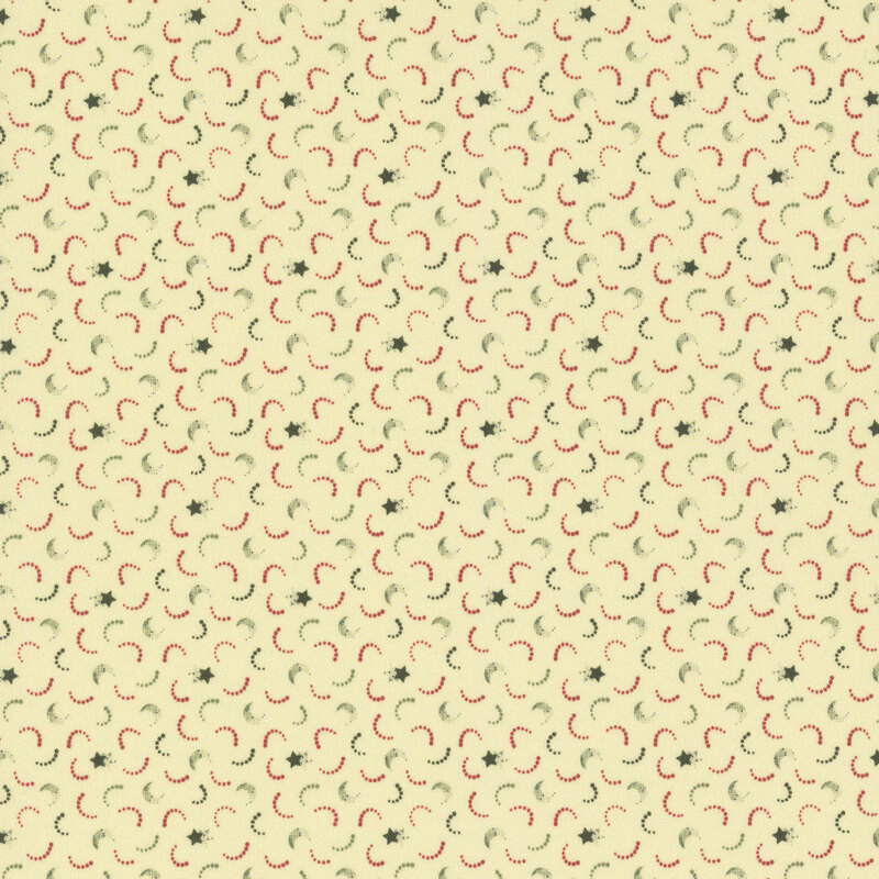 Cream fabric with tossed green stars and red and green dotted arcs.