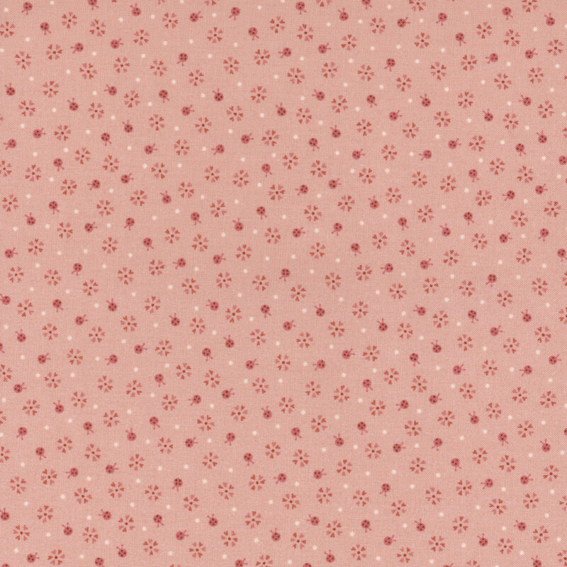 Tonal salmon fabric with small ladybugs, flowers, and pinprick dots.