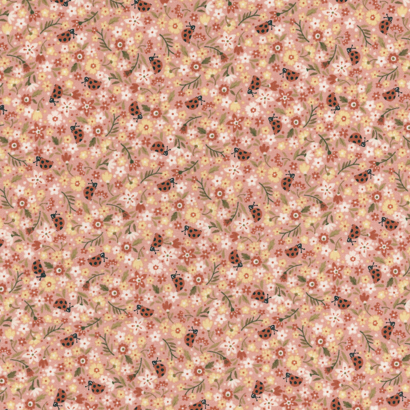 Packed salmon pink fabric with white, yellow, and red flowers amongst tossed ladybugs.