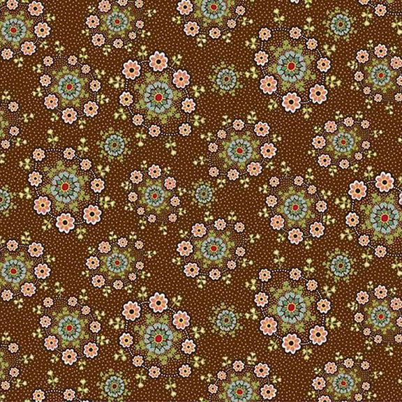 Green and red daisy wreaths tossed on a brown fabric.