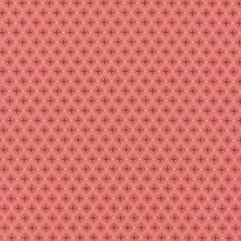 Pink fabric with half-drop red hibiscus flowers.