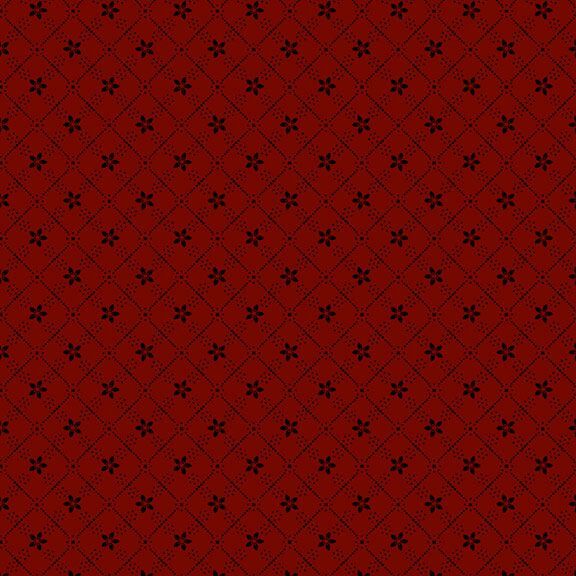 Red patterned fabric with a diamond grid design and small black floral motifs on a deep red background.