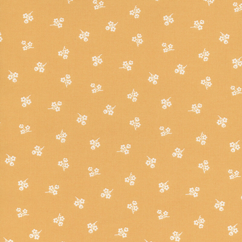 Light orange fabric with a repeating pattern of small white flowers.