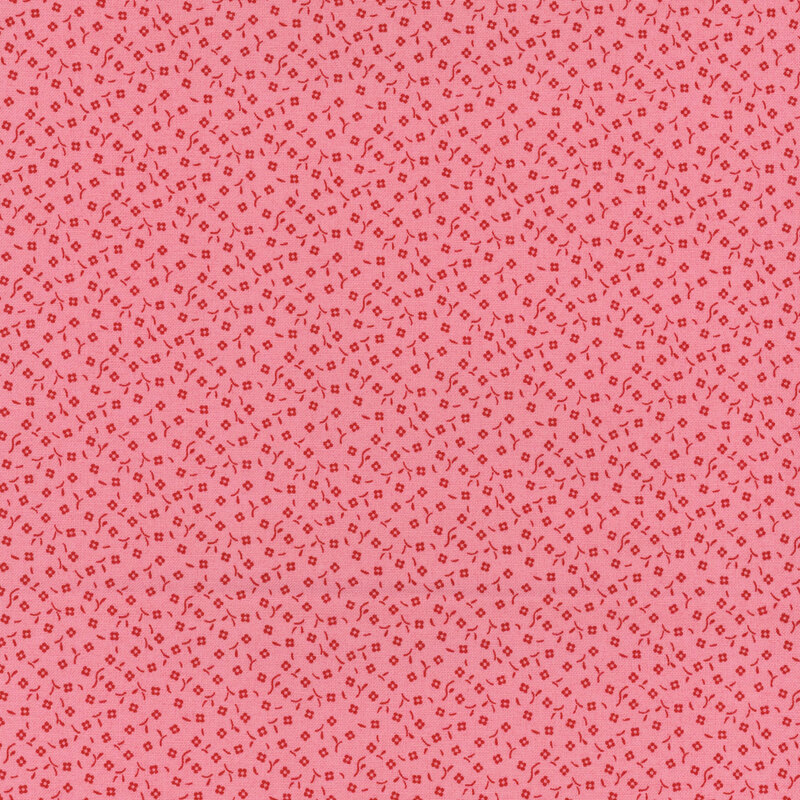Pink fabric featuring a repeated pattern of small square shapes.