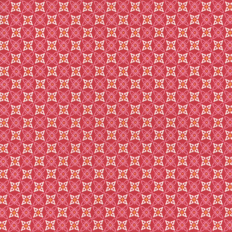 Red fabric with a repeating geometric design of floral shapes.