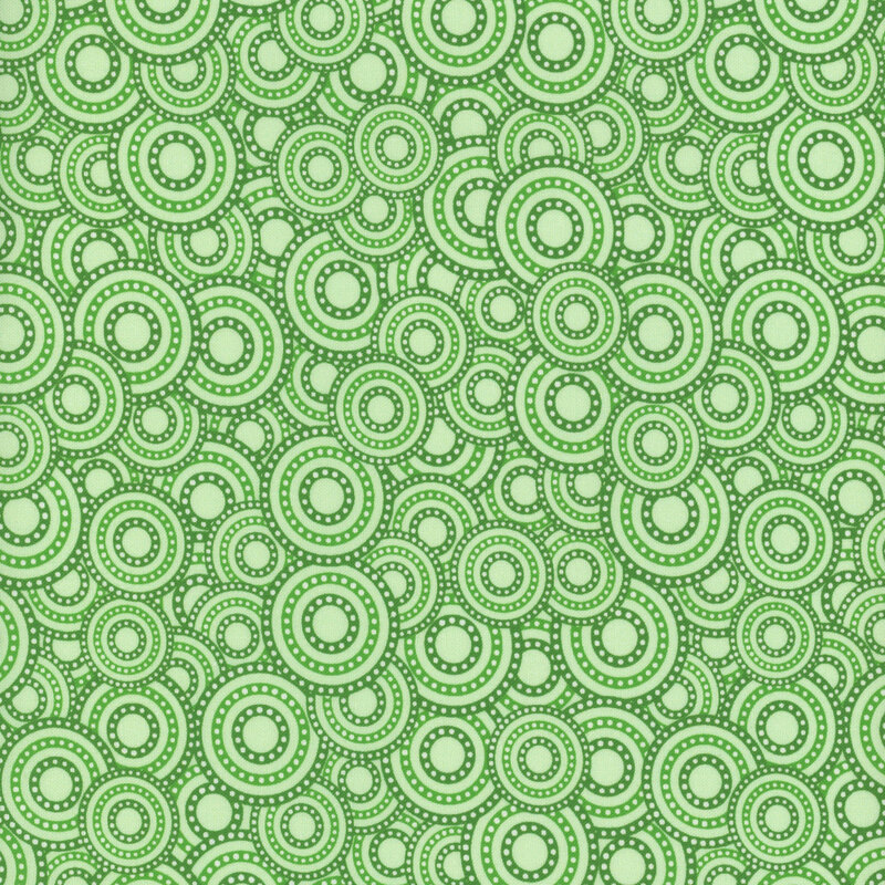Pattern of overlapping green circles with white dots on a light green background.