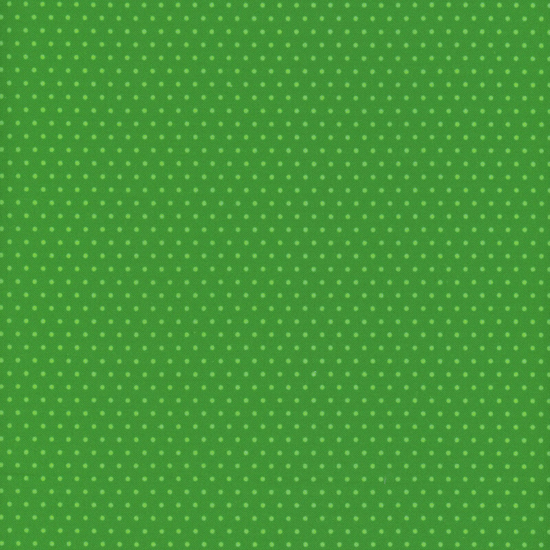 Kelly green fabric with a repeated white polka dot pattern.