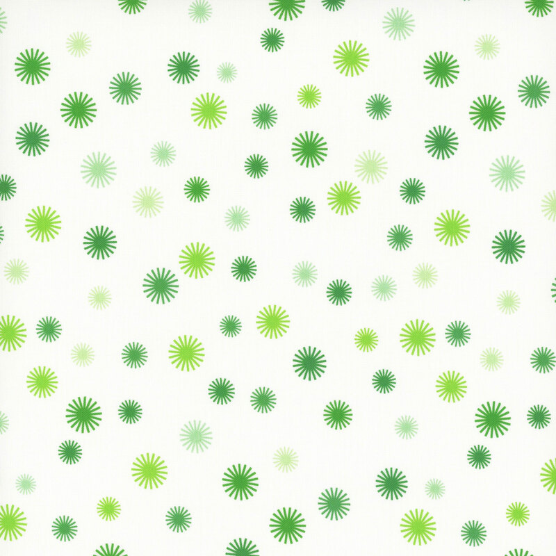 A pattern of various starburst shapes in shades of green on a white background.