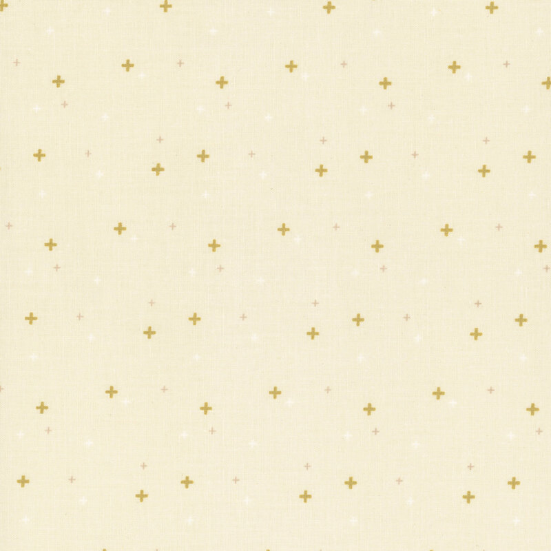 cream fabric with gold metallic plus signs/crossed lines scattered all over.