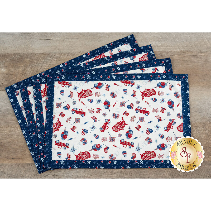 Four patriotic placemats with a white center featuring red, blue, and star patterns on a navy border.