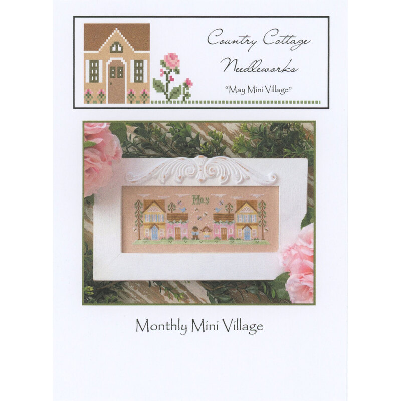 Front of the May Mini Village pattern by Country Cottage Needleworks, featuring a stitched scene of a village in May