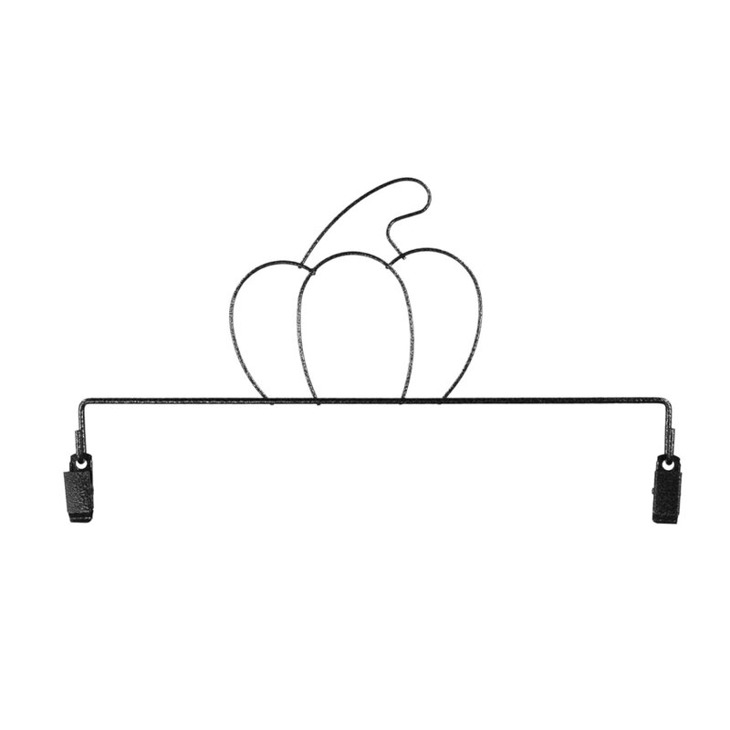 A metal craft holder of a pumpkin with clips.