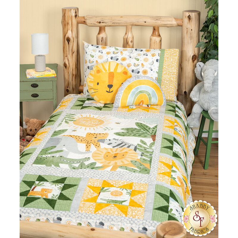 A shot of the quilt staged on a cabin bed with coordinating minky pillows and a Sunny Safari pillowcase.