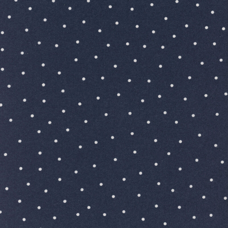 Dark denim blue flannel fabric with scattered white dots.