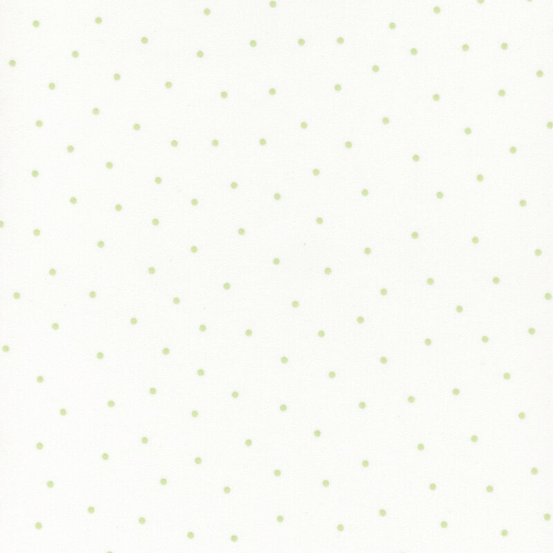 White flannel fabric with scattered light green dots.