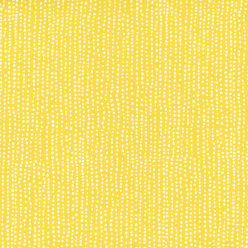 Bright yellow fabric with vertical rows of wobbly white dots.