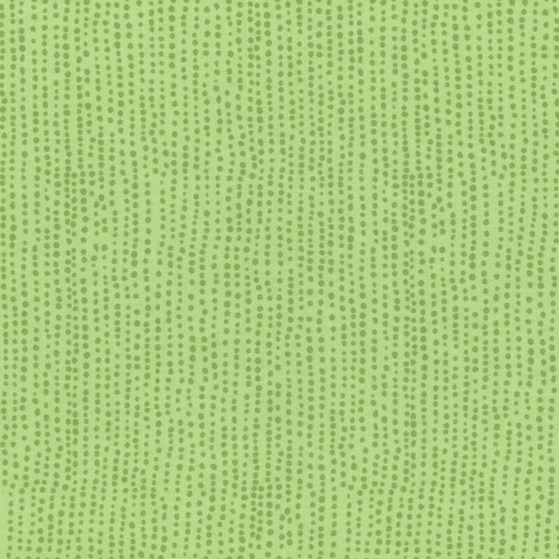 Kiwi green fabric with vertical rows of wobbly green dots.