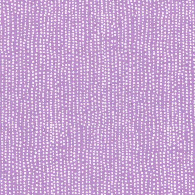 Lavender fabric with vertical rows of wobbly white dots.