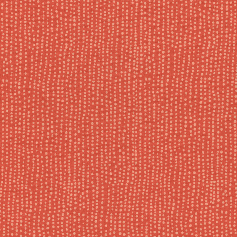 Tangerine orange fabric with vertical rows of wobbly tonal dots.