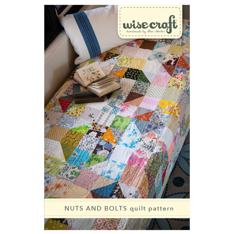 The front of the Nuts & Bolts Quilt Pattern, showing the finished quilt draped over a bed.