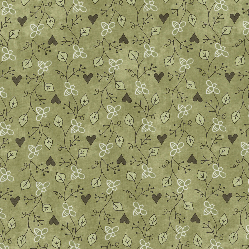 Floral fabric pattern featuring leaves and flowers in white, with black hearts on a mottled sage green background.