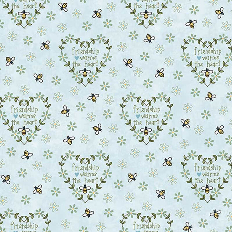 Repeating fabric pattern of pastel blue with hearts, flowers, and bees, featuring the text Friendship warms the heart.