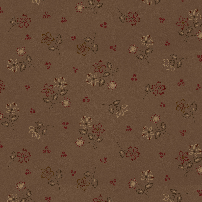 latte and brick red flowers with evergreen leaves and stems scattered on earth brown fabric