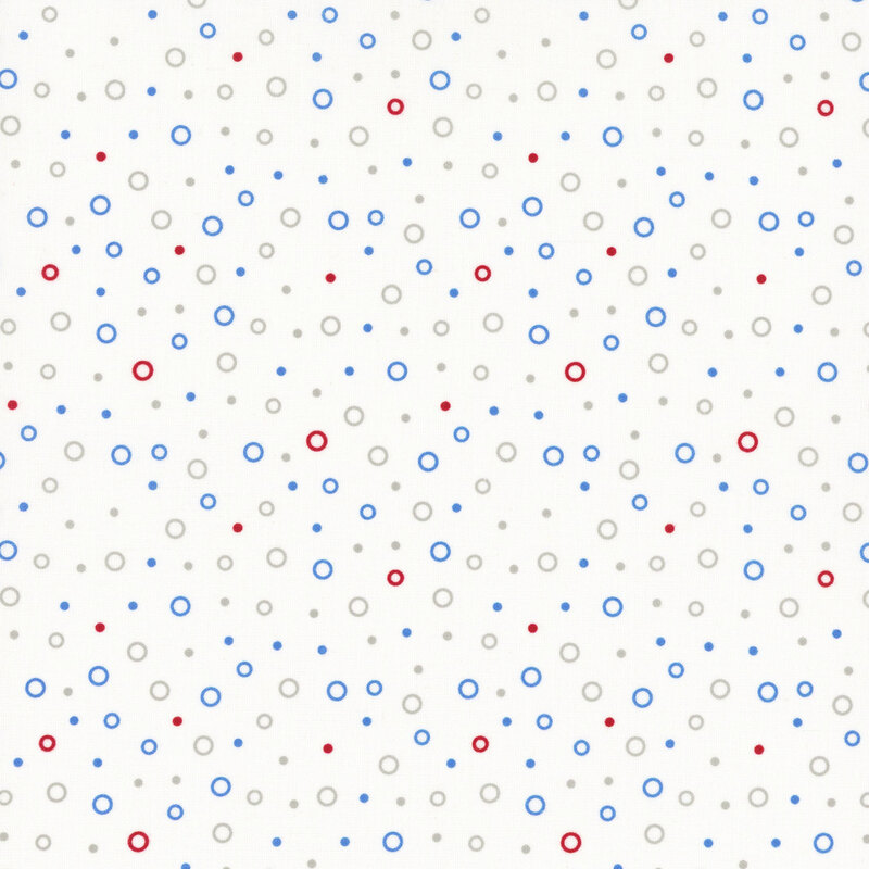 gray, blue, and red circles tossed on white fabric