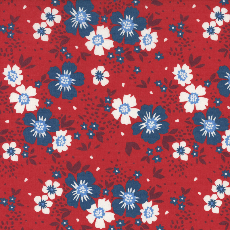 Dark blue and white flowers with dark red leaves tossed on red fabric