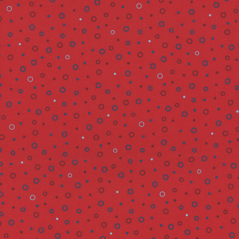 white, blue, and dark red circles tossed on bright red fabric