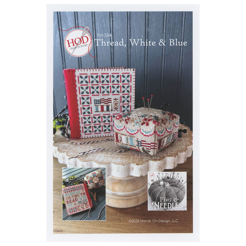 The front of the Thread, White & Blue cross stitch pattern showing the completed projects displayed on a cake stand.