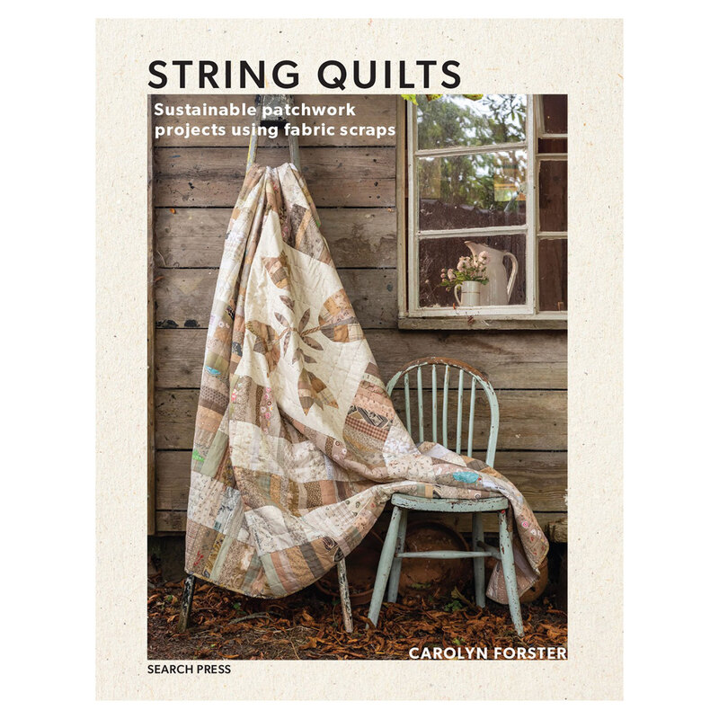 Front cover of the book, showing a muted quilt staged with a country style home and rustic decor.