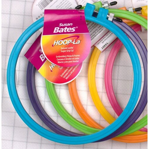 An assortment of colorful Hoop-la embroidery hoops on a white background