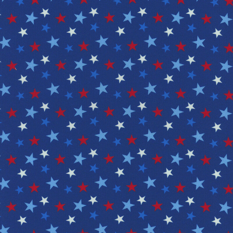 A blue fabric filled with red, white, and light blue stars in a random pattern.