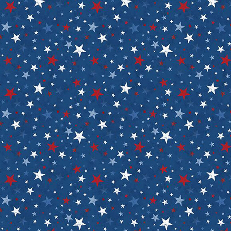 Red, white, and blue stars tossed on mottled navy blue fabric.