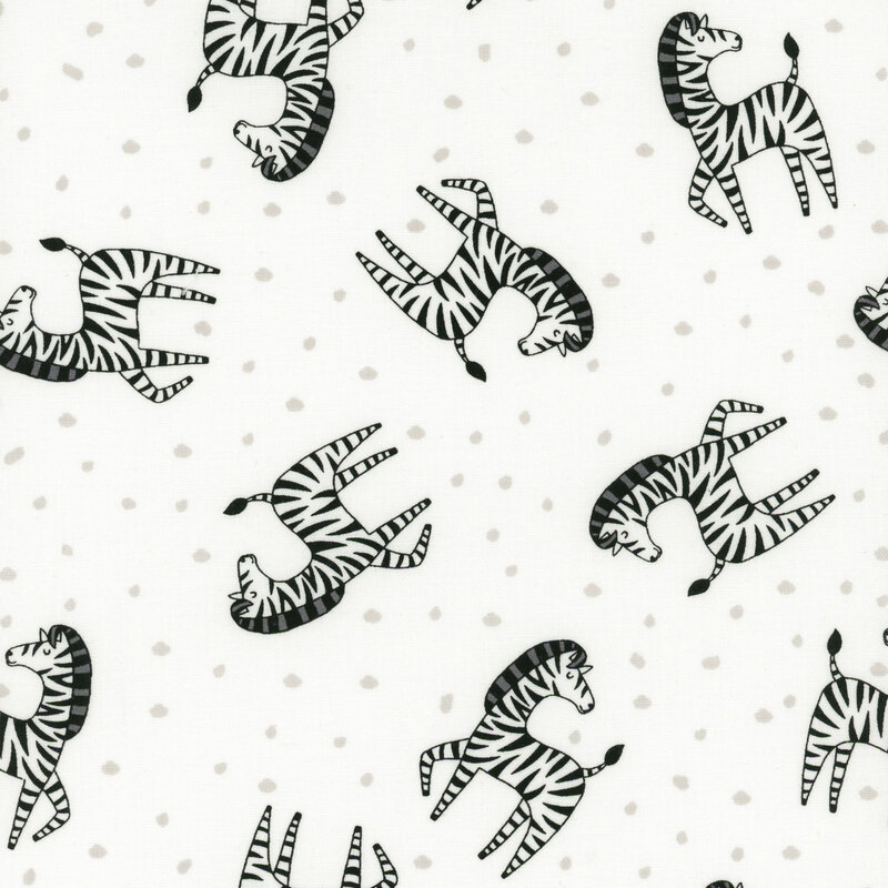 White fabric tossed with stripped zebras and silver dots.