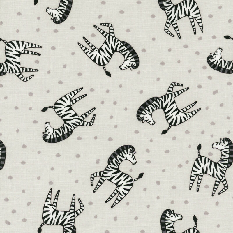 Soft gray fabric tossed with stripped zebras and silver dots.