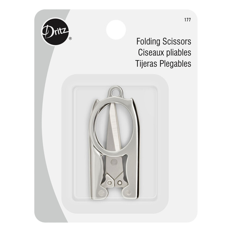 A shiny silver pair of folding scissors, folded and encased in their paper and plastic packaging.