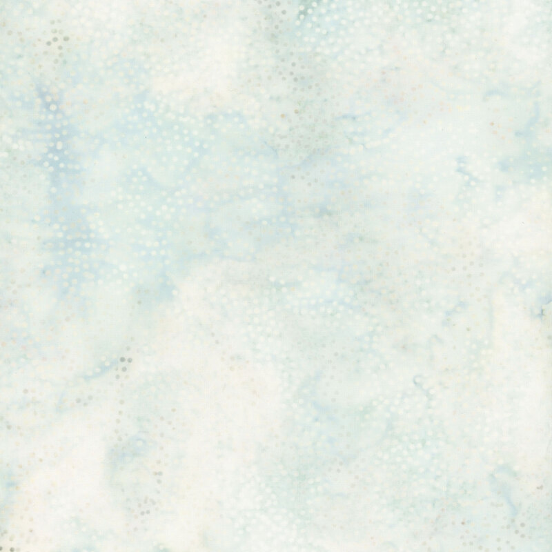Mottled white and aqua batik fabric with small white scattered dots.