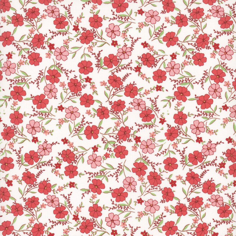 Cream fabric with a calico pattern of tossed with red and pink flowers with green leaves.