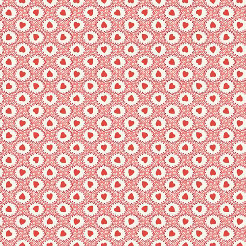 Pattern of geometric shapes in coral pink surrounding red hearts on white fabric.