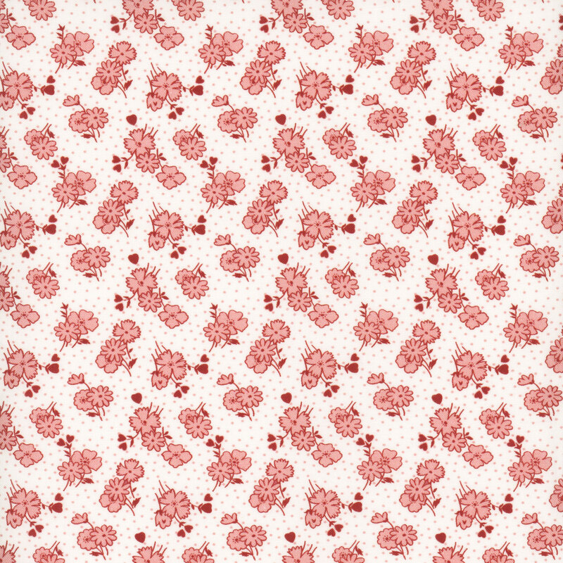 White fabric featuring coral pink daisy blossoms and hearts with a pink dotted background.