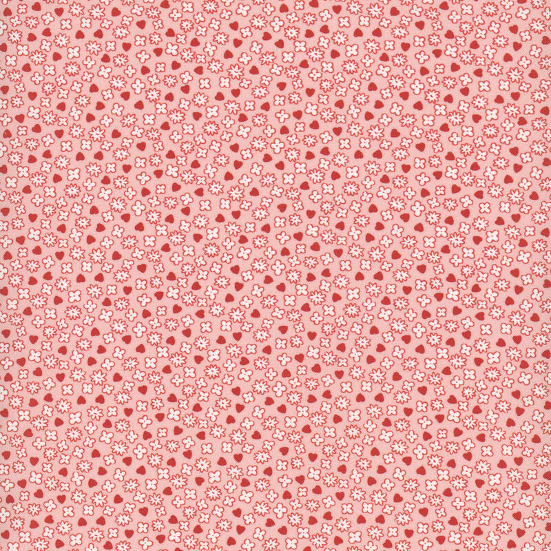 Coral fabric featuring a small pattern of evenly spaced white flowers and red hearts.