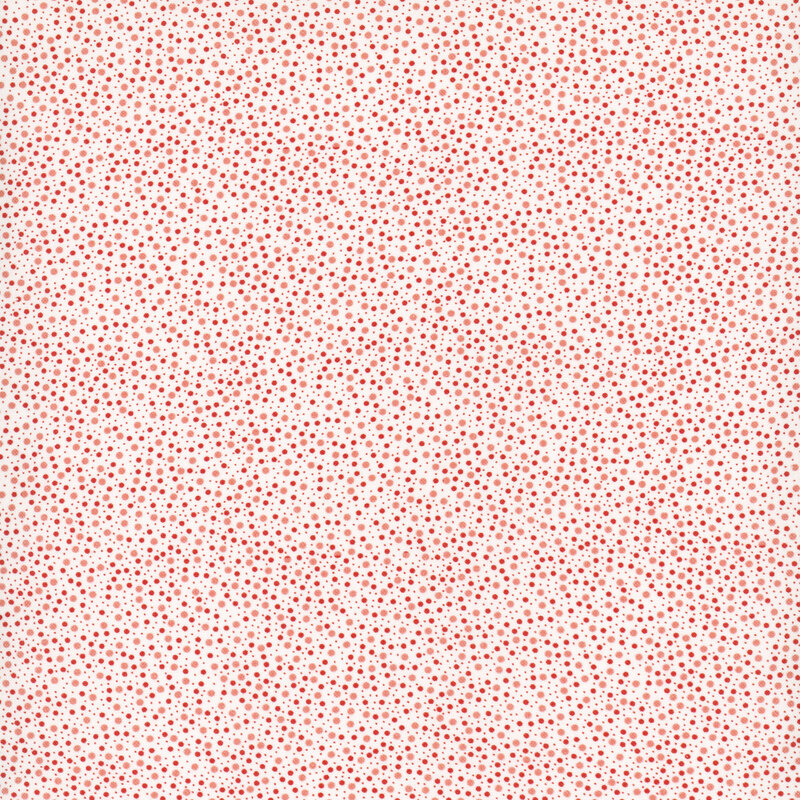White fabric with scattered red, coral, and salmon colored dots in various sizes.