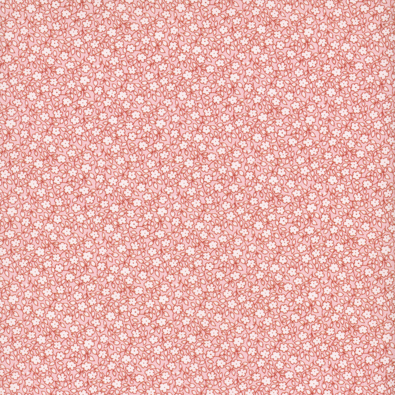 White flowers and leaves packed on pastel pink fabric.