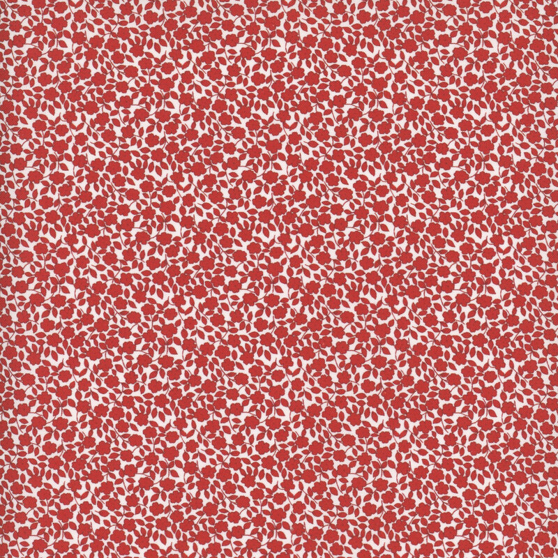 Cherry red flowers and leaves packed on white fabric.