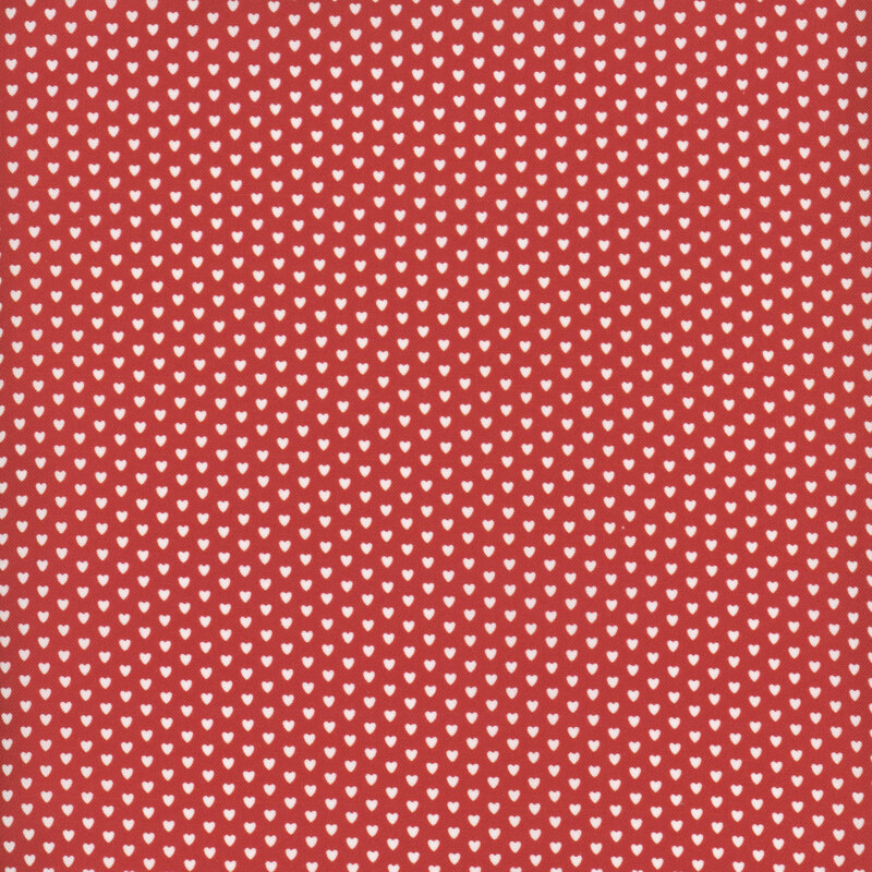Scarlet fabric dotted with evenly spaced rows of white hearts