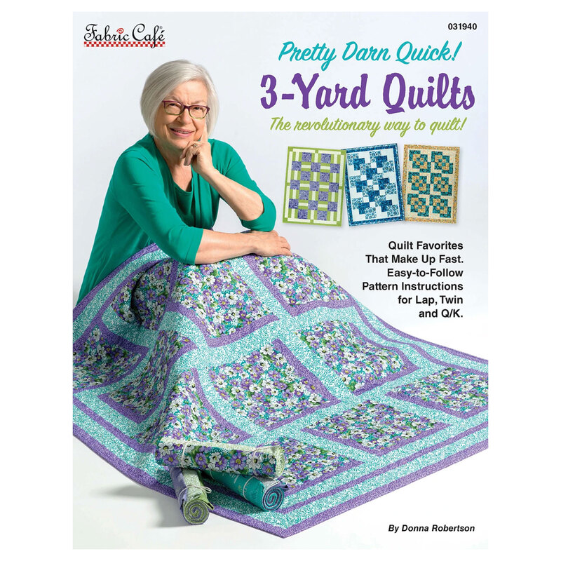 The front of the Pretty Darn Quick! 3-Yard Quilts book, featuring Donna Robertson sitting on the ground with a quilt draped over her lap.