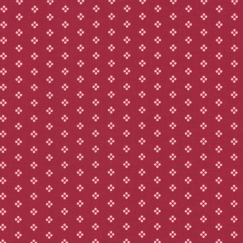 Dark red fabric with white dots arranged in groups.