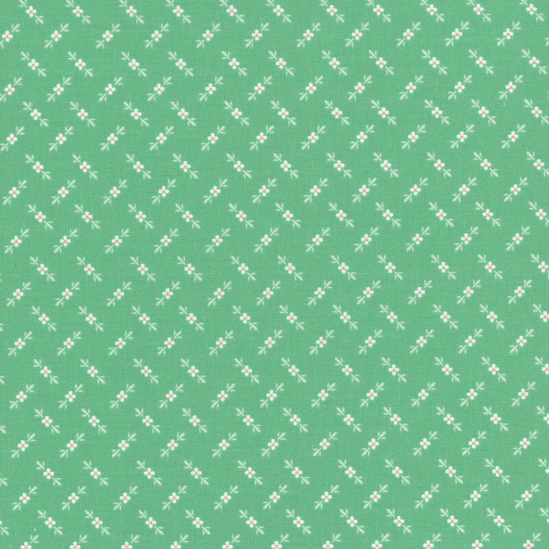 Kelly green fabric featuring a ditsy pattern of a white, pink, and teal floral design.